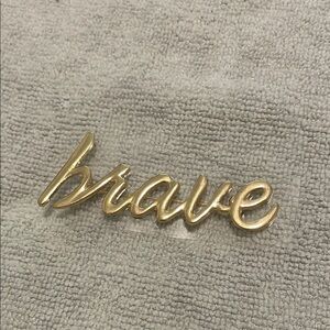Gold 'Brave' pin